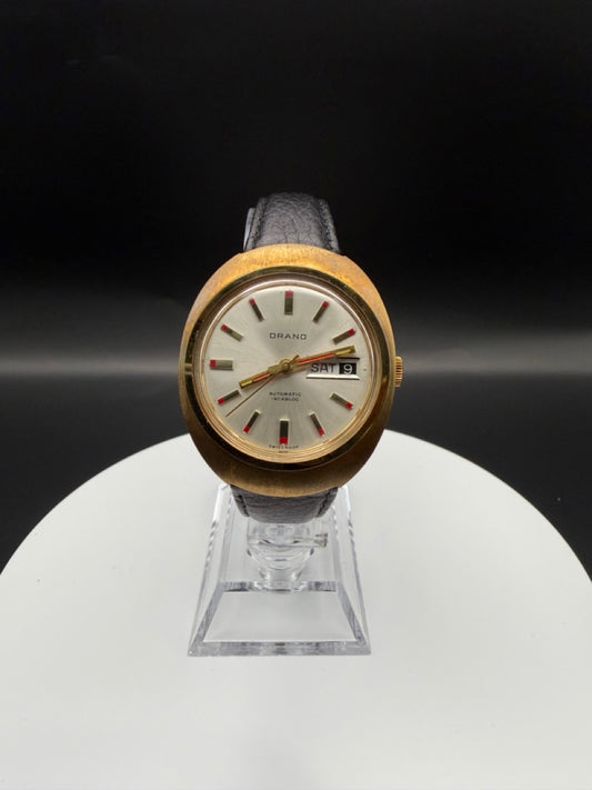 Montre Orano NOS Swiss Made Automatique day date vintage aiguilles rouges