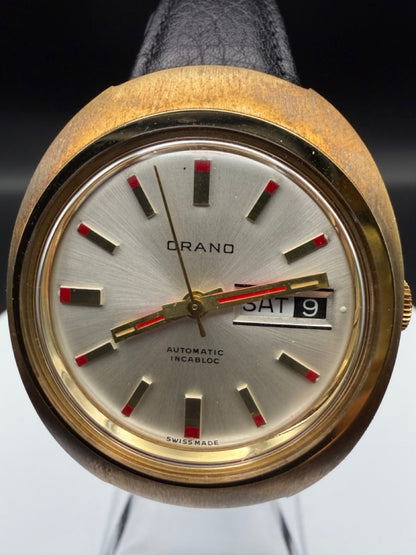 Montre Orano NOS Swiss Made Automatique day date vintage aiguilles rouges