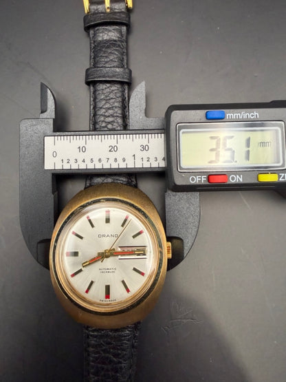 Montre Orano NOS Swiss Made Automatique day date vintage aiguilles rouges